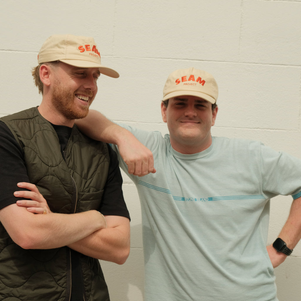 Two men wearing visors against a plain background